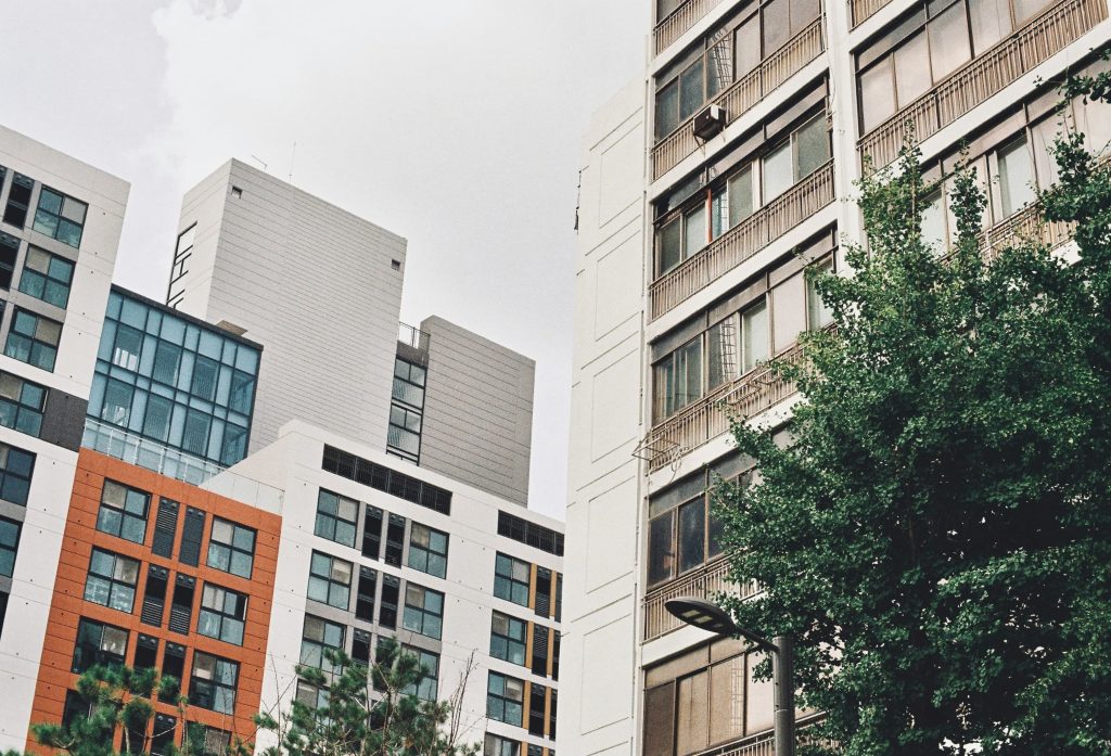 Modern mid-rise apartment buildings with colorful facades in a Korean residential neighborhood