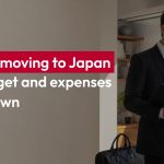 Foreigner preparing to move to Japan with luggage and relocation documents in a modern apartment