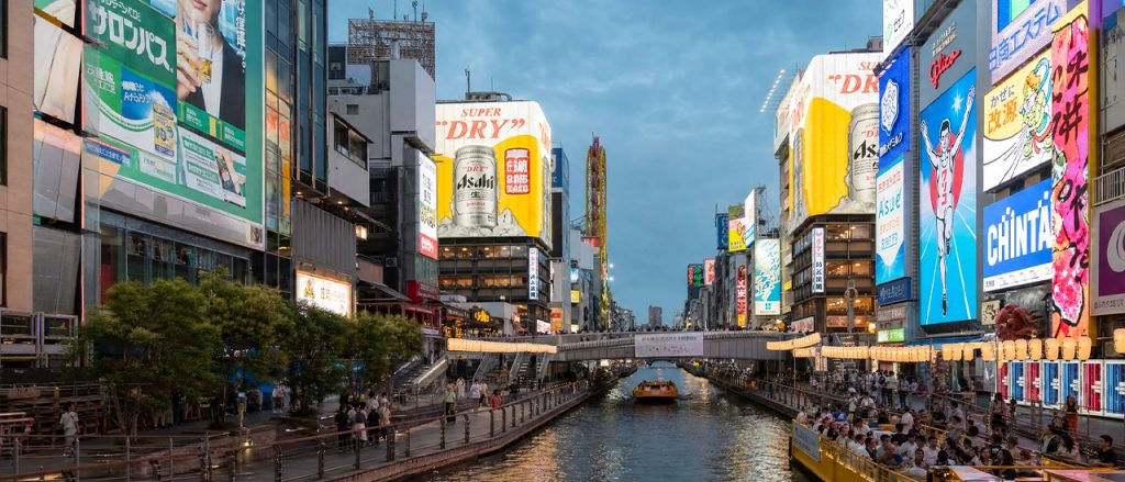 Dotonbori Canal in Osaka featuring the iconic Glico Running Man sign, one of the city's most vibrant districts and a popular place to live in Japan for foreigners.