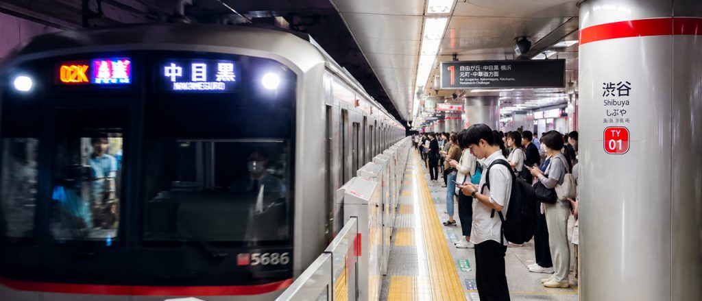 A Tokyo subway platform in summer with a train departing, showcasing Japan's fast and reliable public transportation for people living in Tokyo.